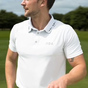 A golfer wearing a golf polo that was designed in a performance-stretch material with moisture managing properties for all day comfort.