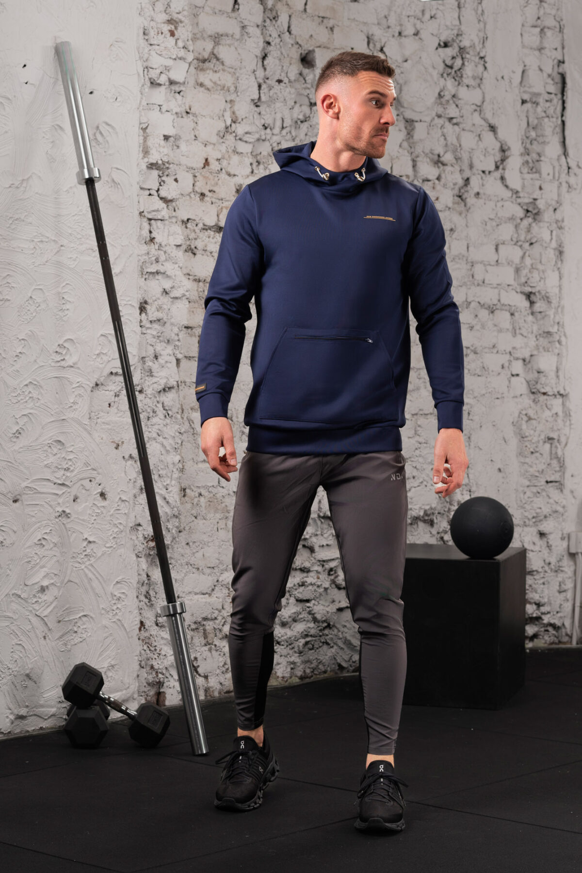 The Integrity Unisex Hoodie (Navy) is a sleek functional pullover style with integrated pockets. Scuba like material for warmth in the colder months, with a high neckline and drawstrings for defined coverage for the perfect pre and post workout hoodie.