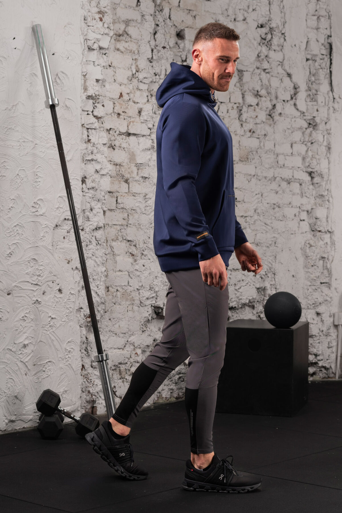 The Integrity Unisex Hoodie (Navy) is a sleek functional pullover style with integrated pockets. Scuba like material for warmth in the colder months, with a high neckline and drawstrings for defined coverage for the perfect pre and post workout hoodie.