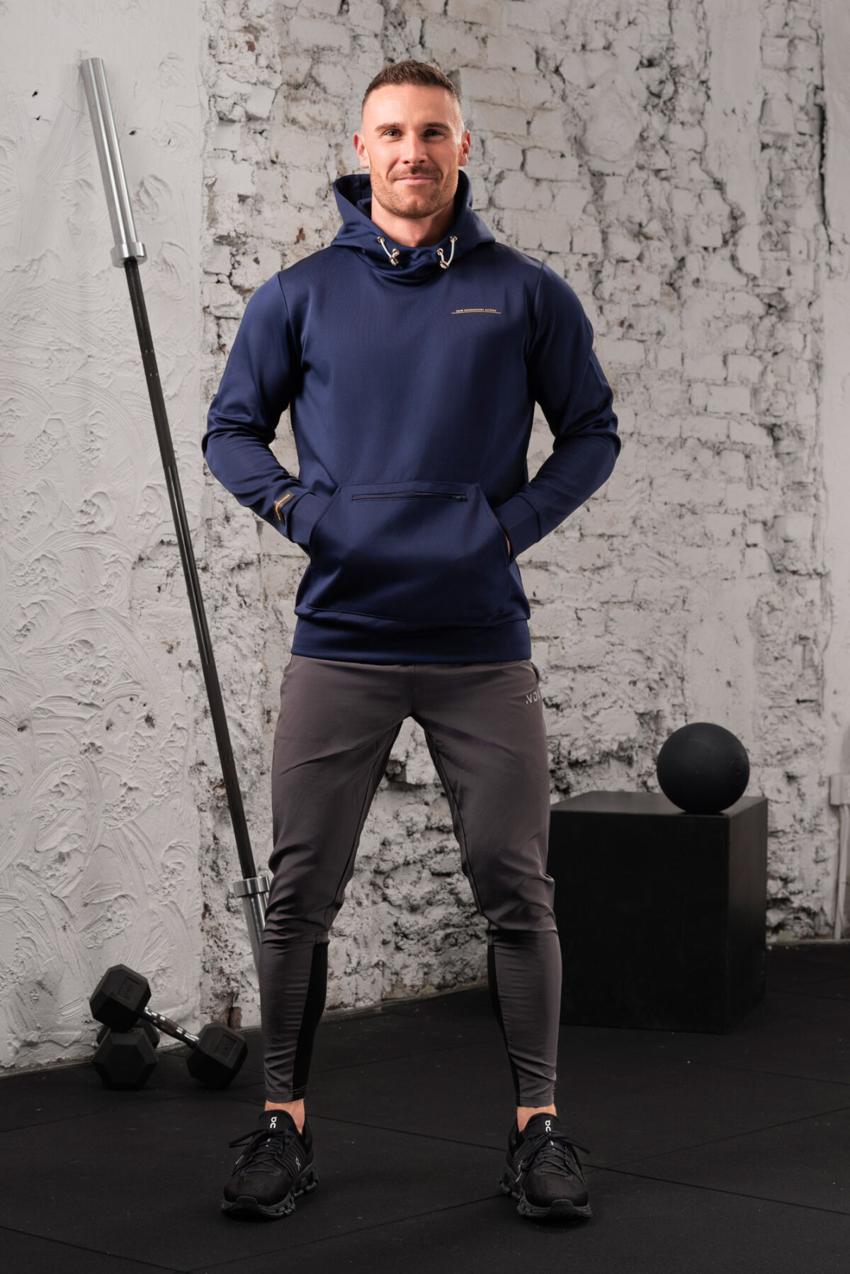 The Integrity Unisex Hoodie (Navy) is a sleek functional pullover style with integrated pockets. Scuba like material for warmth in the colder months, with a high neckline and drawstrings for defined coverage for the perfect pre and post workout hoodie.