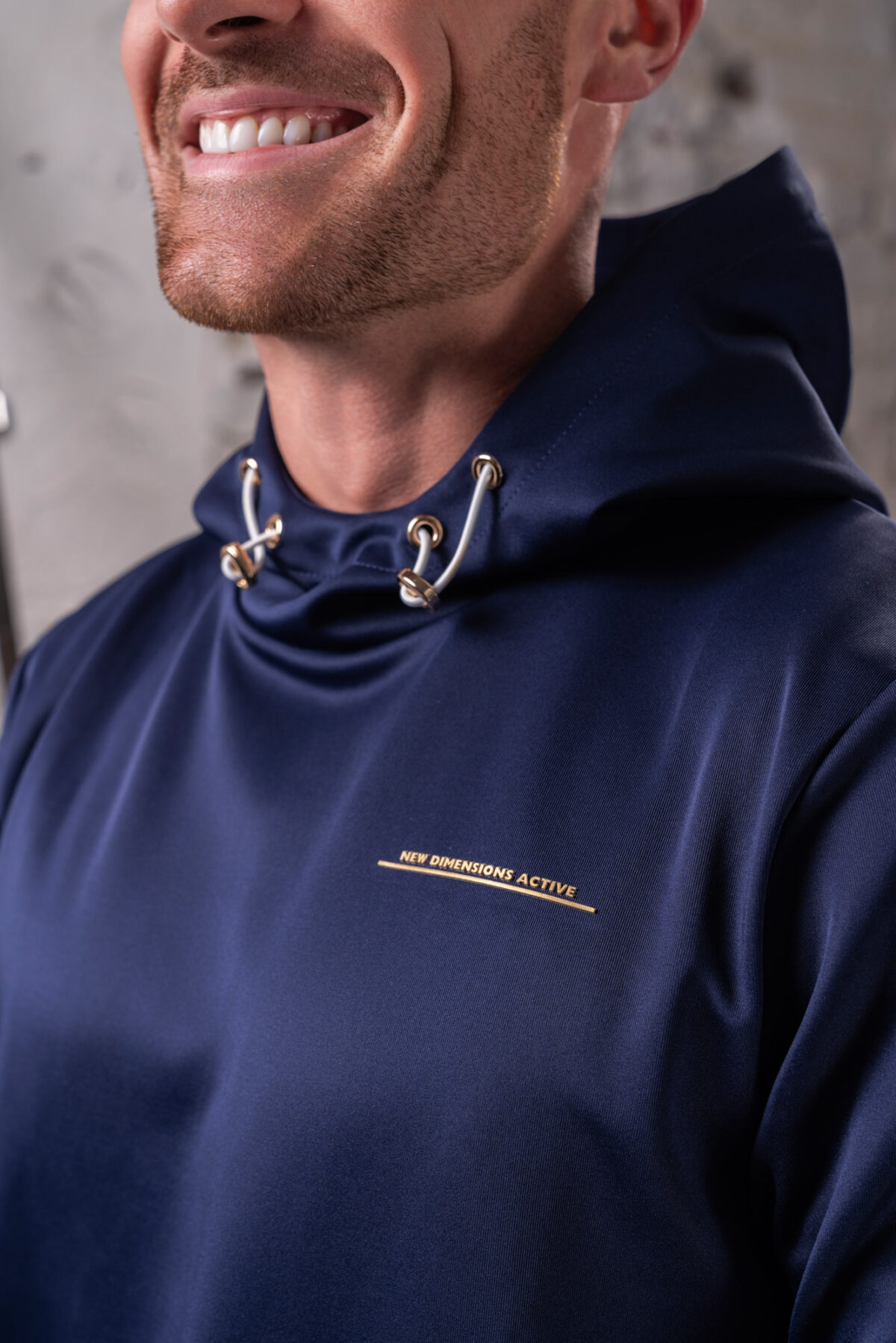 The Integrity Unisex Hoodie (Navy) is a sleek functional pullover style with integrated pockets. Scuba like material for warmth in the colder months, with a high neckline and drawstrings for defined coverage for the perfect pre and post workout hoodie.