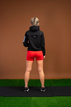 The Women’s Tempo Jacket (Black) is designed with functional fabric that helps keep any moisture away from your skin, keeping you dry throughout your run or HIIT session. Cropped style with a 4 way stretch ensures comfort and mobility. The elasticated hood that stays in place while you move, with a full zip front and pockets allows for a safe workout. Elasticated hem for the perfect fit and reflective details makes this the ideal warm weather running jacket.
