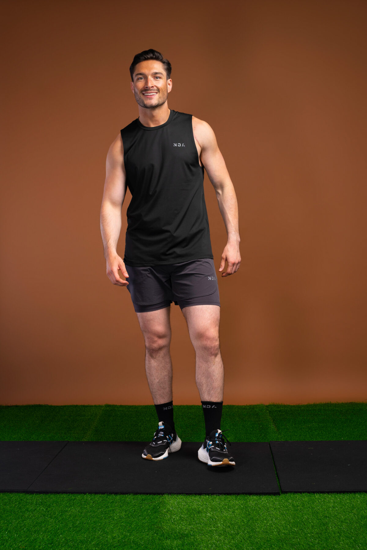 The Tempo Tank Top (Black) is a must-have for any active man who wants to stay cool and comfortable during his workouts. The lightweight compression material is designed to keep you cool and dry, while the vented sides provide extra breathability. The no-sleeve design allows you to move freely without feeling restricted. Get ready to take your workouts to the next level.