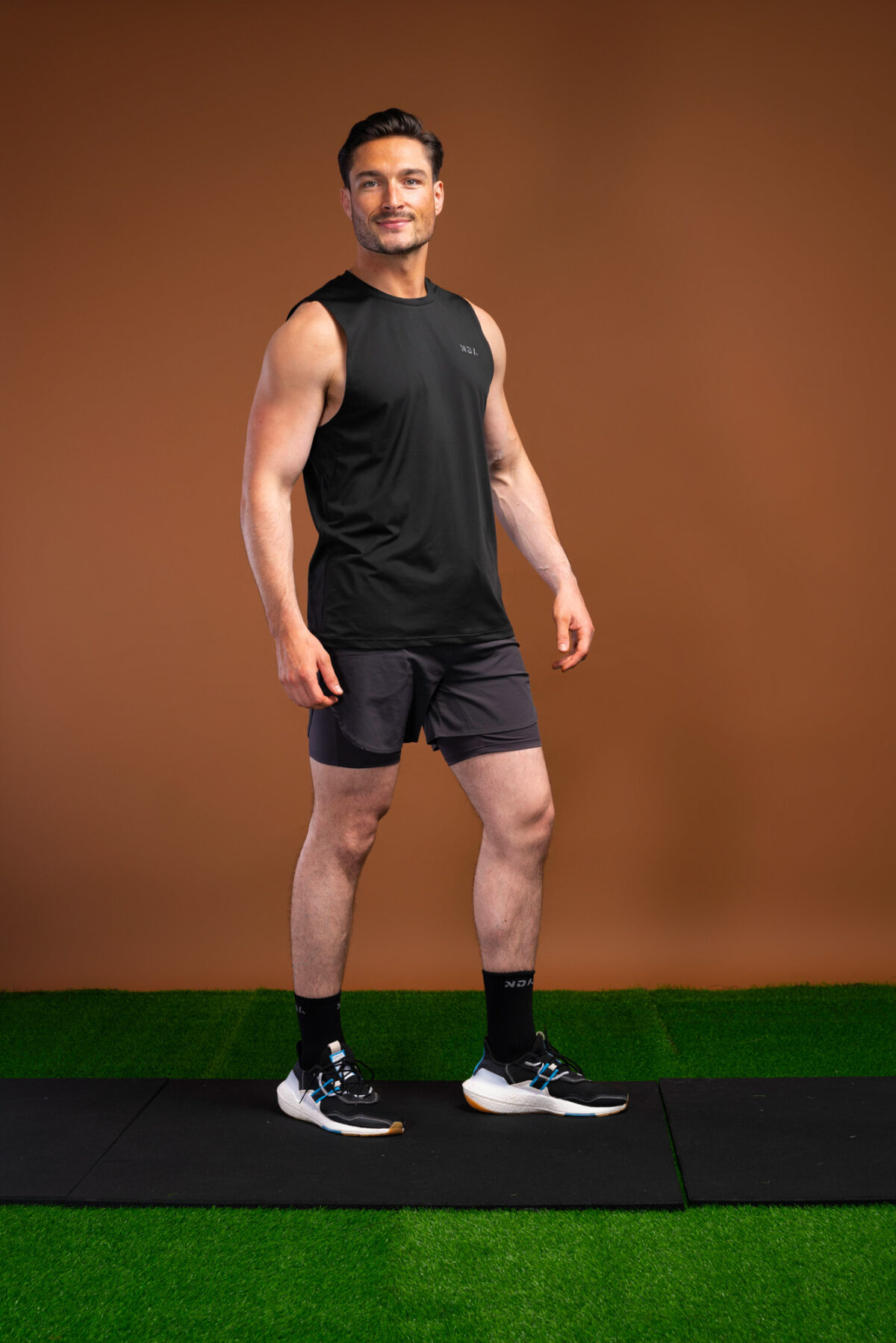 The Tempo Tank Top (Black) is a must-have for any active man who wants to stay cool and comfortable during his workouts. The lightweight compression material is designed to keep you cool and dry, while the vented sides provide extra breathability. The no-sleeve design allows you to move freely without feeling restricted. Get ready to take your workouts to the next level.