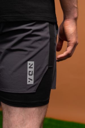 Introducing the revolutionary Benchmark Performance Shorts (Grey)! Our new innovation is disguised as a 2 in 1, but is in fact an outer layer attached to the under layer to optimise movement and provide the best performance possible. These shorts are made from a lightweight and breathable fabric that is designed to provide a comfortable fit and move with you. The fabric is also water-resistant, so you can stay dry and comfortable no matter the activity. The four-way stretch fabric ensures that you have the full range of movement needed to perform your best.
