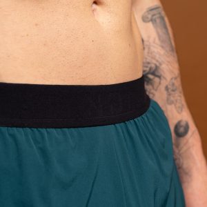 Introducing the revolutionary Benchmark Performance Shorts (Dark Teal)! Our new innovation is disguised as a 2 in 1, but is in fact an outer layer attached to the under layer to optimise movement and provide the best performance possible. These shorts are made from a lightweight and breathable fabric that is designed to provide a comfortable fit and move with you. The fabric is also water-resistant, so you can stay dry and comfortable no matter the activity. The four-way stretch fabric ensures that you have the full range of movement needed to perform your best.