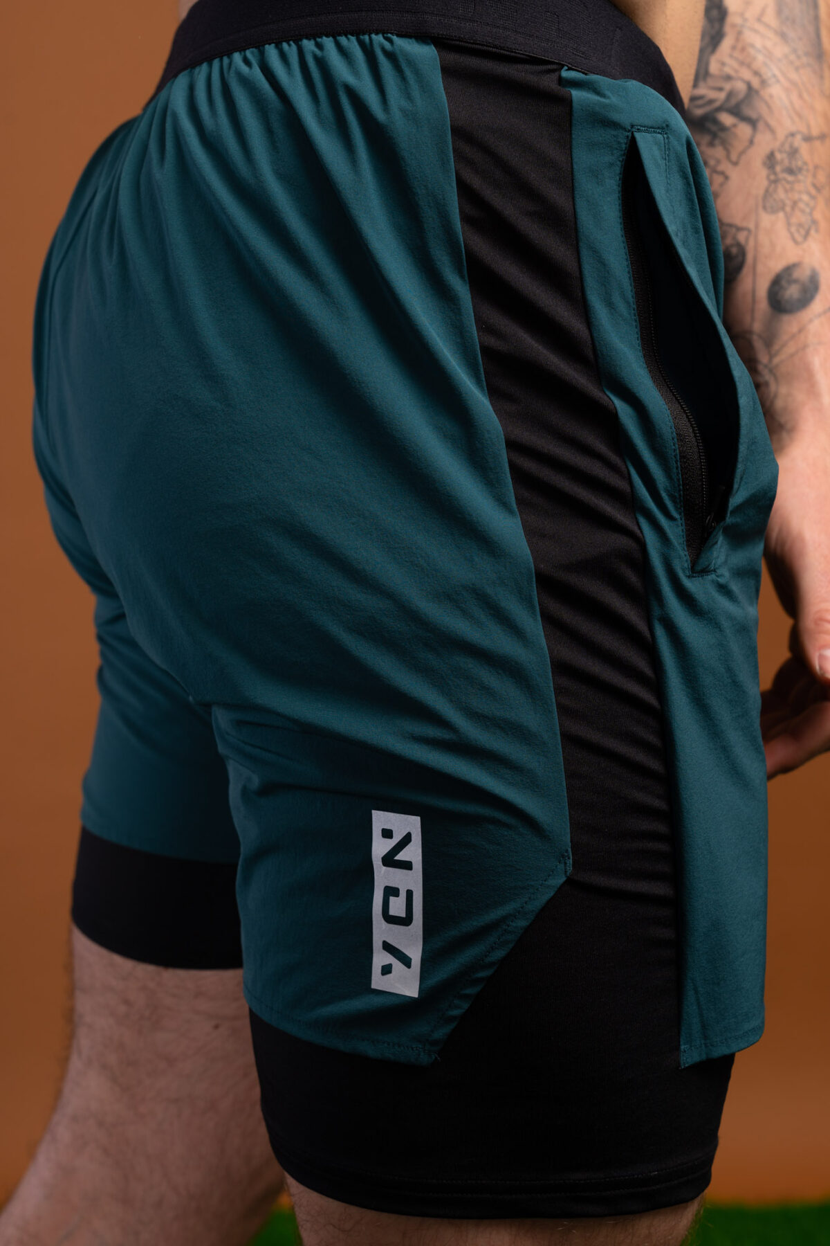 Introducing the revolutionary Benchmark Performance Shorts (Dark Teal)! Our new innovation is disguised as a 2 in 1, but is in fact an outer layer attached to the under layer to optimise movement and provide the best performance possible. These shorts are made from a lightweight and breathable fabric that is designed to provide a comfortable fit and move with you. The fabric is also water-resistant, so you can stay dry and comfortable no matter the activity. The four-way stretch fabric ensures that you have the full range of movement needed to perform your best.