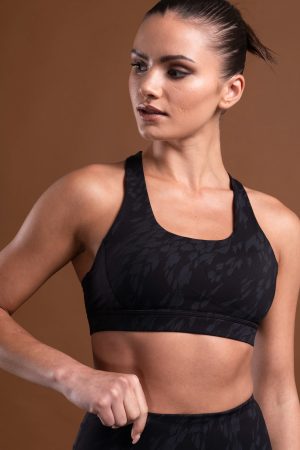The perfect mix of two of our signature materials, our elite and compression 3.0 have combined to make this buttery soft Resilient Sports Bra (Black). This bra is designed to provide maximum support and comfort during your most intense workouts. The new print pattern and criss cross back detail make this sports bra a stylish and functional choice for any active lifestyle.
