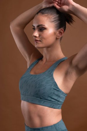 The perfect mix of two of our signature materials, our elite and compression 3.0 have combined to make this buttery soft Resilient Sports Bra (Teal). This bra is designed to provide maximum support and comfort during your most intense workouts. The new print pattern and criss cross back detail make this sports bra a stylish and functional choice for any active lifestyle.