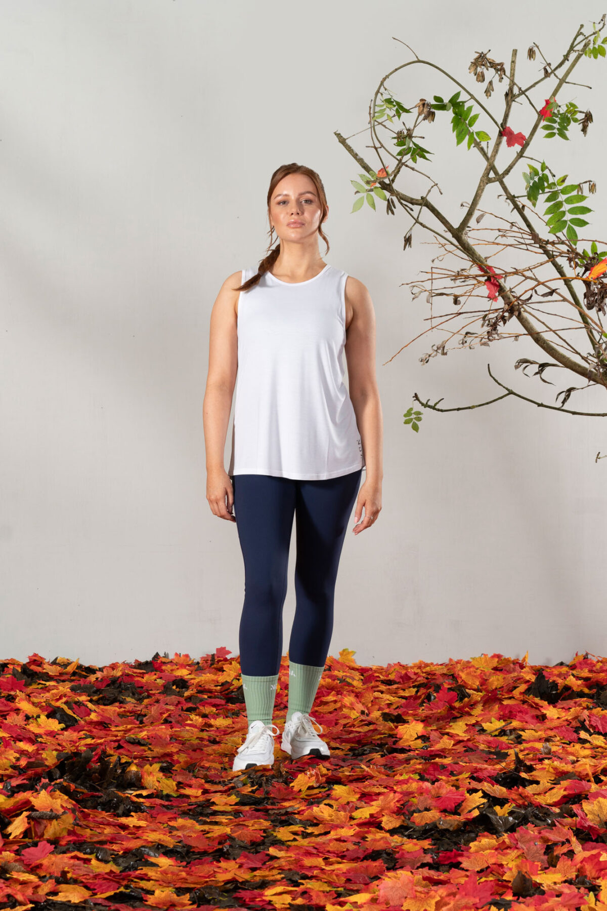 Elevate Vest Top (White). Made from moisture-wicking fabric, this lightweight and breathable top offers maximum movement and flexibility.