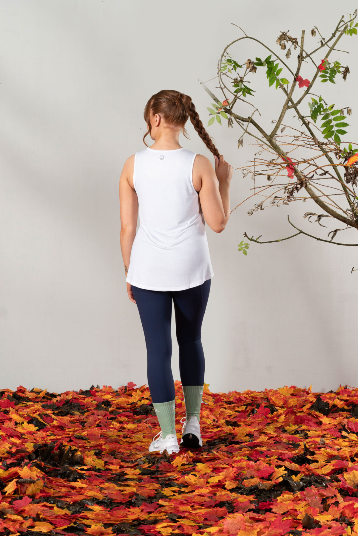 Elevate Vest Top (White). Made from moisture-wicking fabric, this lightweight and breathable top offers maximum movement and flexibility.