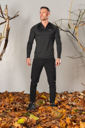 Elevate ¼ Zip (Black), the ultimate performance top. Made with a perfect blend of polyester and spandex, this top offers unparalleled comfort and flexibility. Whether you're warming up or cooling down, the Elevate 1/4 Zip has you covered.