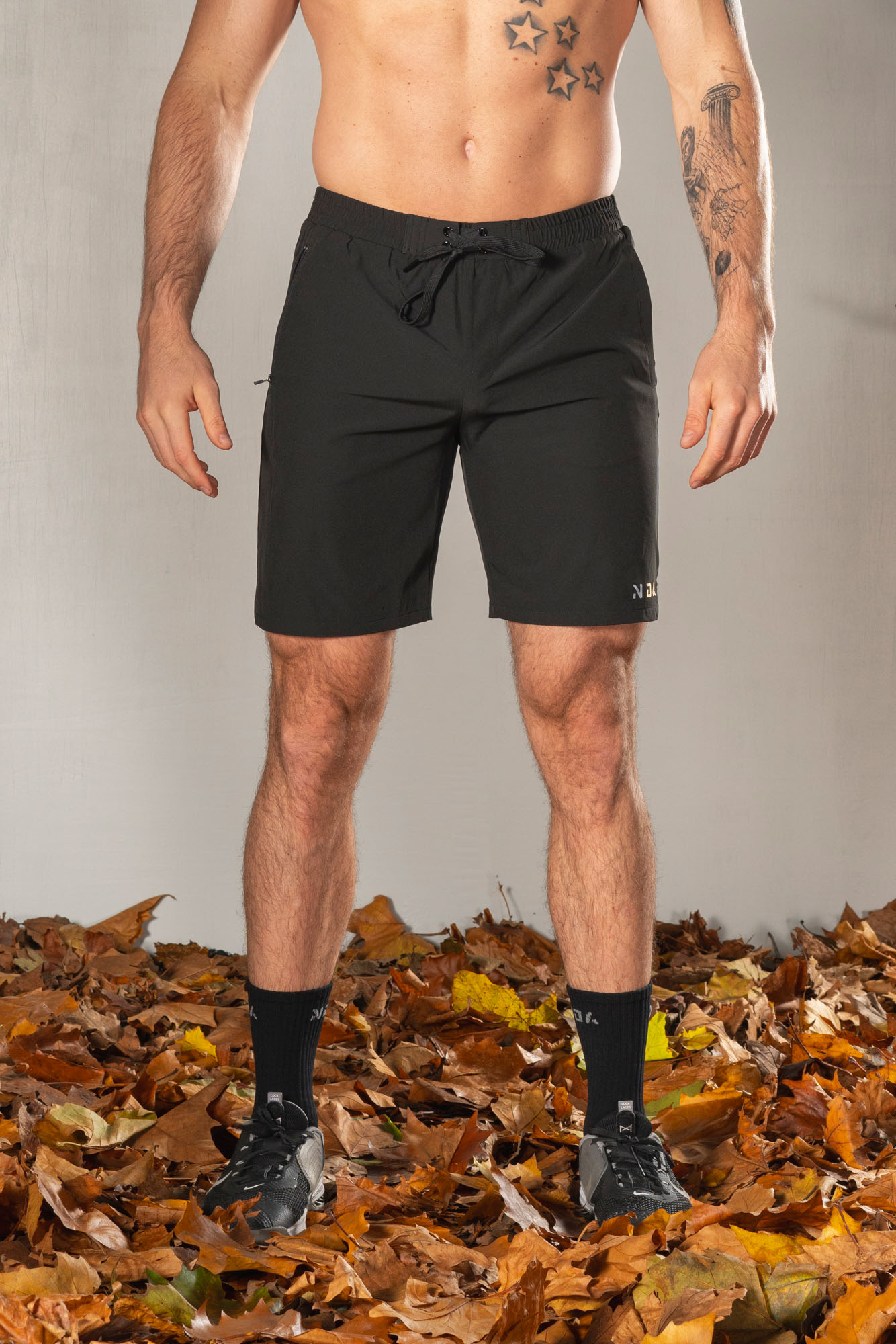 Elevate Men's Shorts (Black), the perfect combination of style and functionality. Crafted with lightweight material, these shorts provide ultimate comfort and breathability for all your activities. Featuring two side pockets and an additional zip pocket, you can easily store your essentials while on the move.