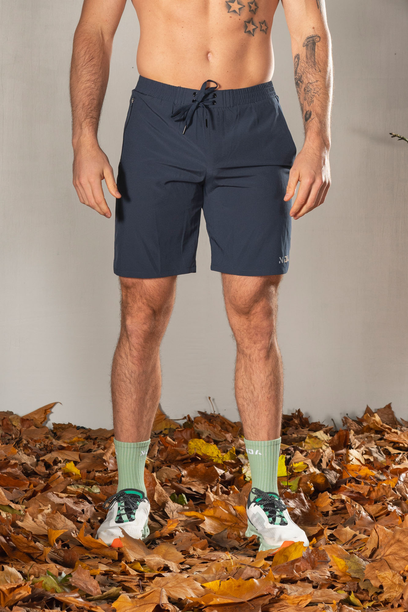 Elevate Men's Shorts (Navy), the perfect combination of style and functionality. Crafted with lightweight material, these shorts provide ultimate comfort and breathability for all your activities. Featuring two side pockets and an additional zip pocket, you can easily store your essentials while on the move.