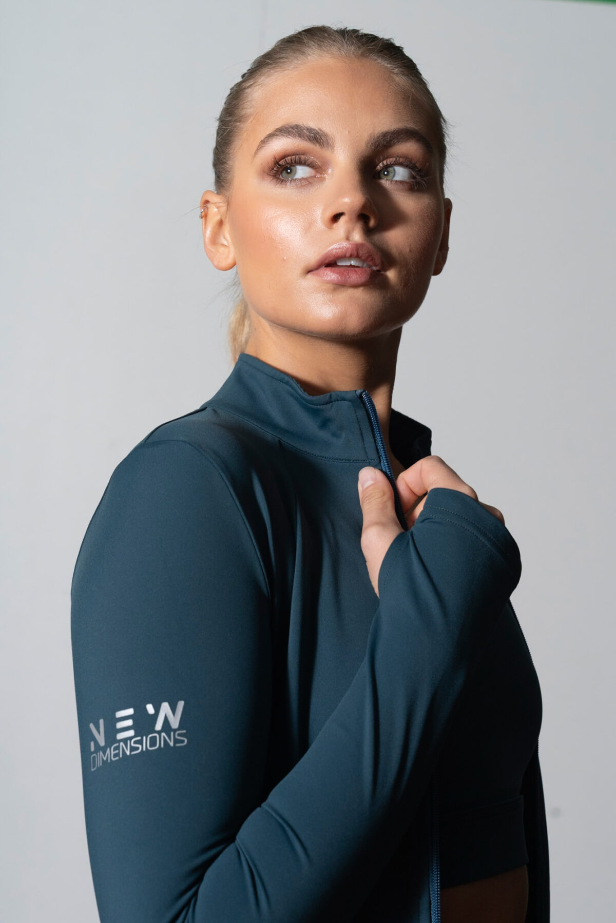 Elevate Zip Jacket (Teal). Crafted from premium compression material, this full zip jacket offers a snug fit with full range of motion.