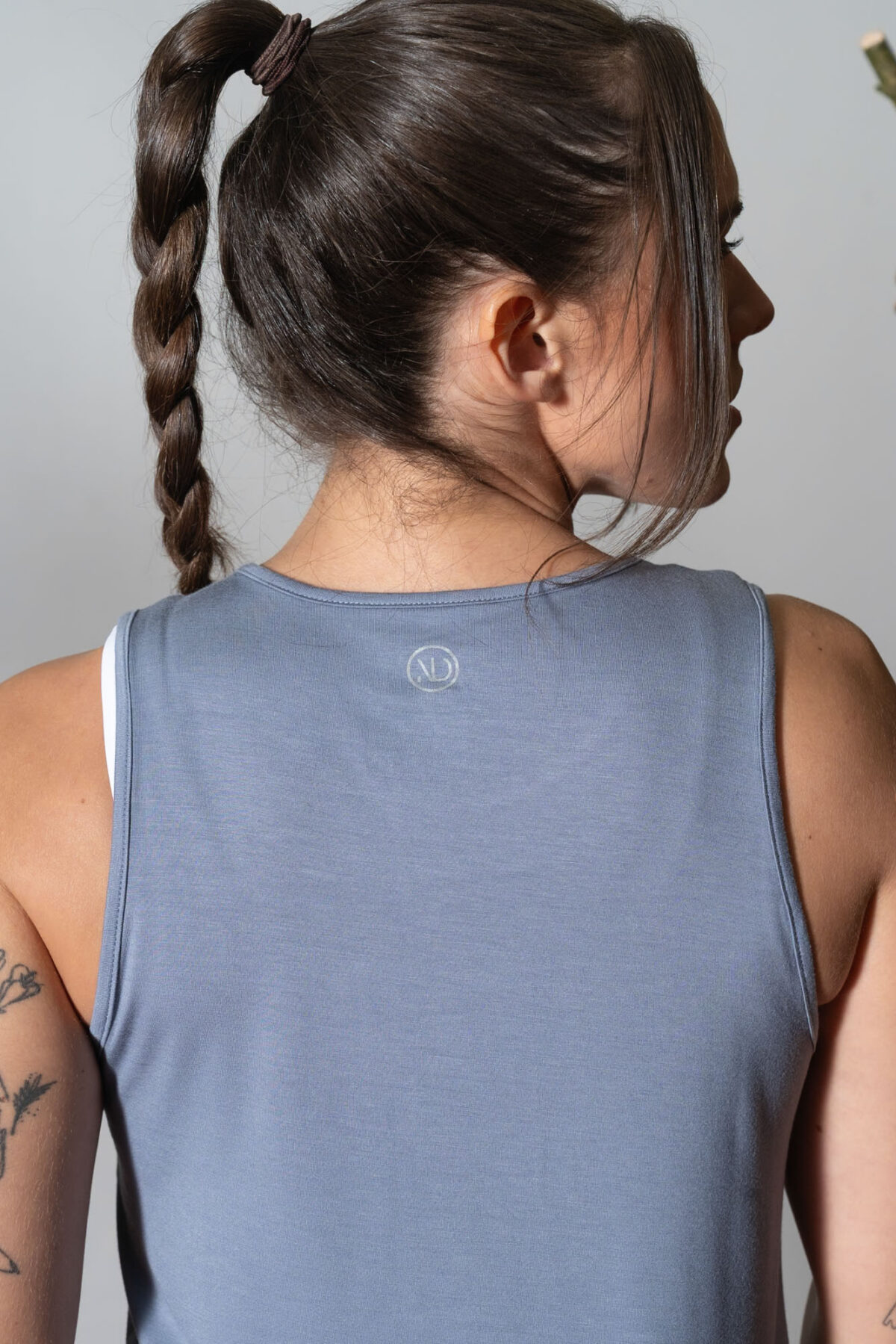 Elevate Vest Top (Steel). Made from moisture-wicking fabric, this lightweight and breathable top offers maximum movement and flexibility.