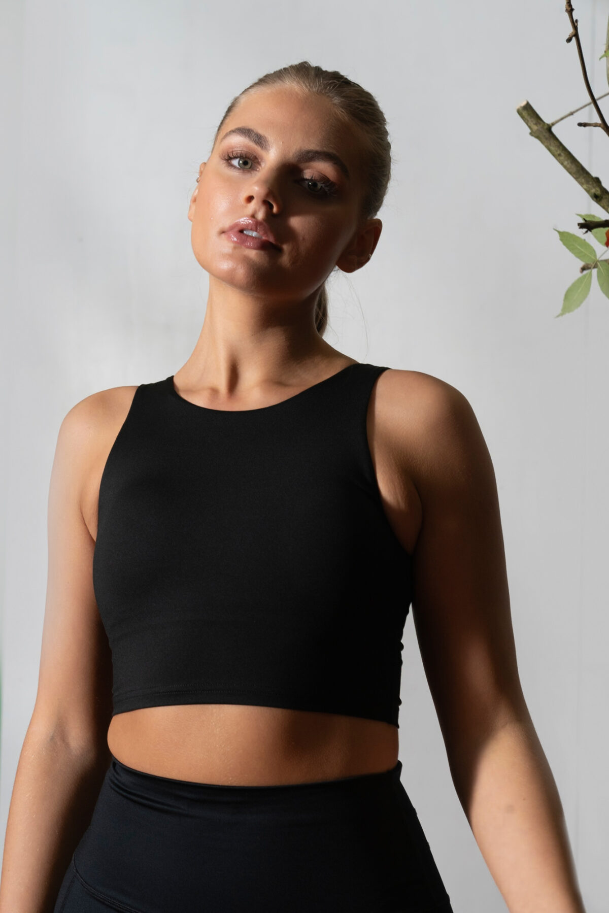 Elevate 2in1 Top (Black). Featuring a built-in under bra and seamless design, this top offers unbeatable support and a flattering silhouette.