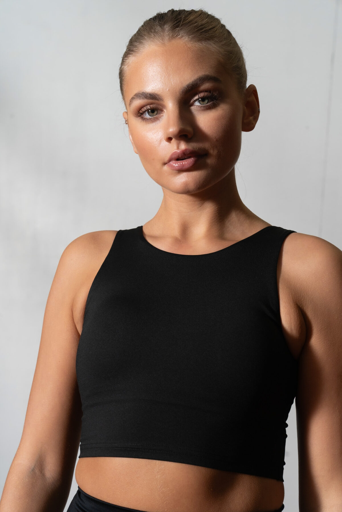 Elevate 2in1 Top (Black). Featuring a built-in under bra and seamless design, this top offers unbeatable support and a flattering silhouette.