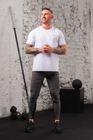 The Benchmark Tee (White) is designed to keep up with your active lifestyle. It’s the perfect choice for any workout, from running to lifting to lounging. The lightweight cotton blend material keeps you cool and comfortable, while the 8 way stretch material allows for unrestricted movement. The short sleeve design and high neckline provide additional coverage, and the reflective logos add a touch of style.
