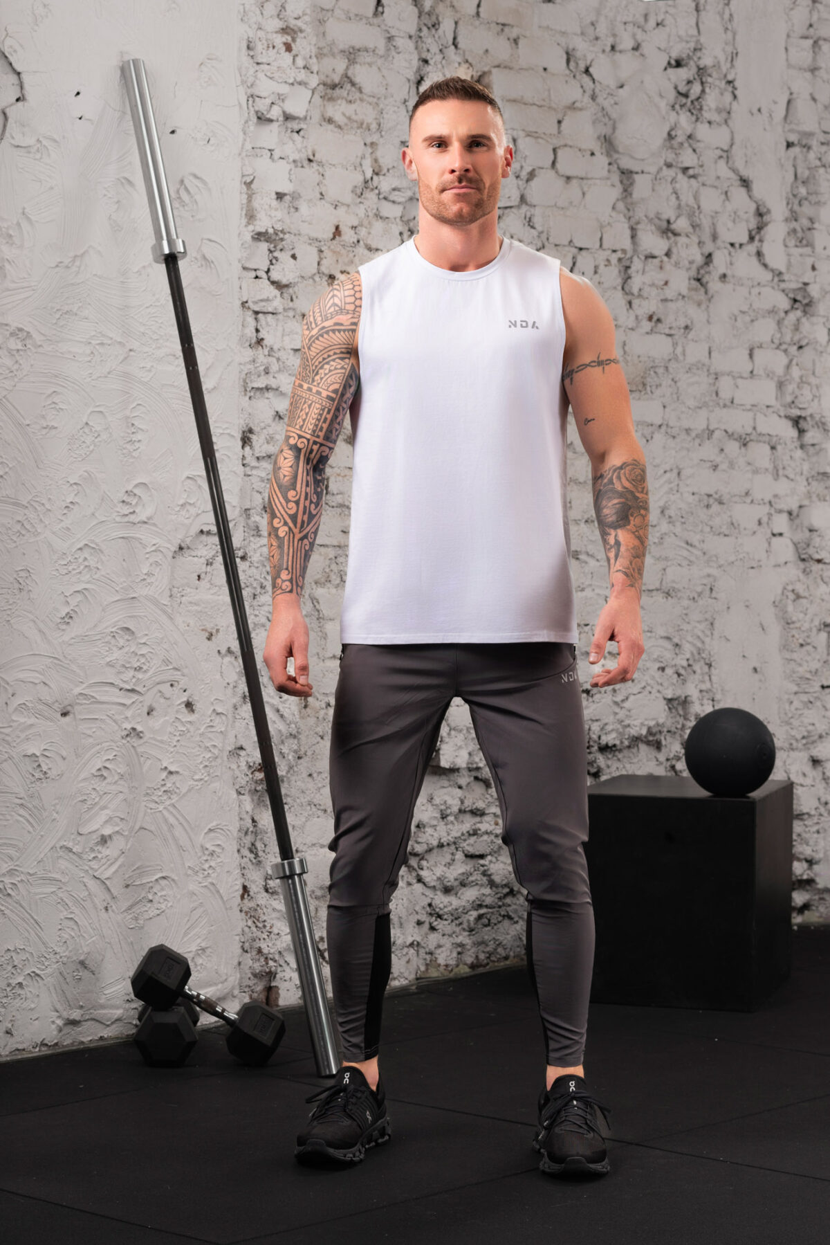 The Benchmark Tank Top (White) is designed to keep you cool and comfortable in any situation. The cotton blend material is soft and breathable, allowing air to circulate freely and keeping you cool. The stretch in the material ensures you can move without feeling restricted. The sleeveless design and high neckline give you a stylish look, while the lightweight material won’t weigh you down.