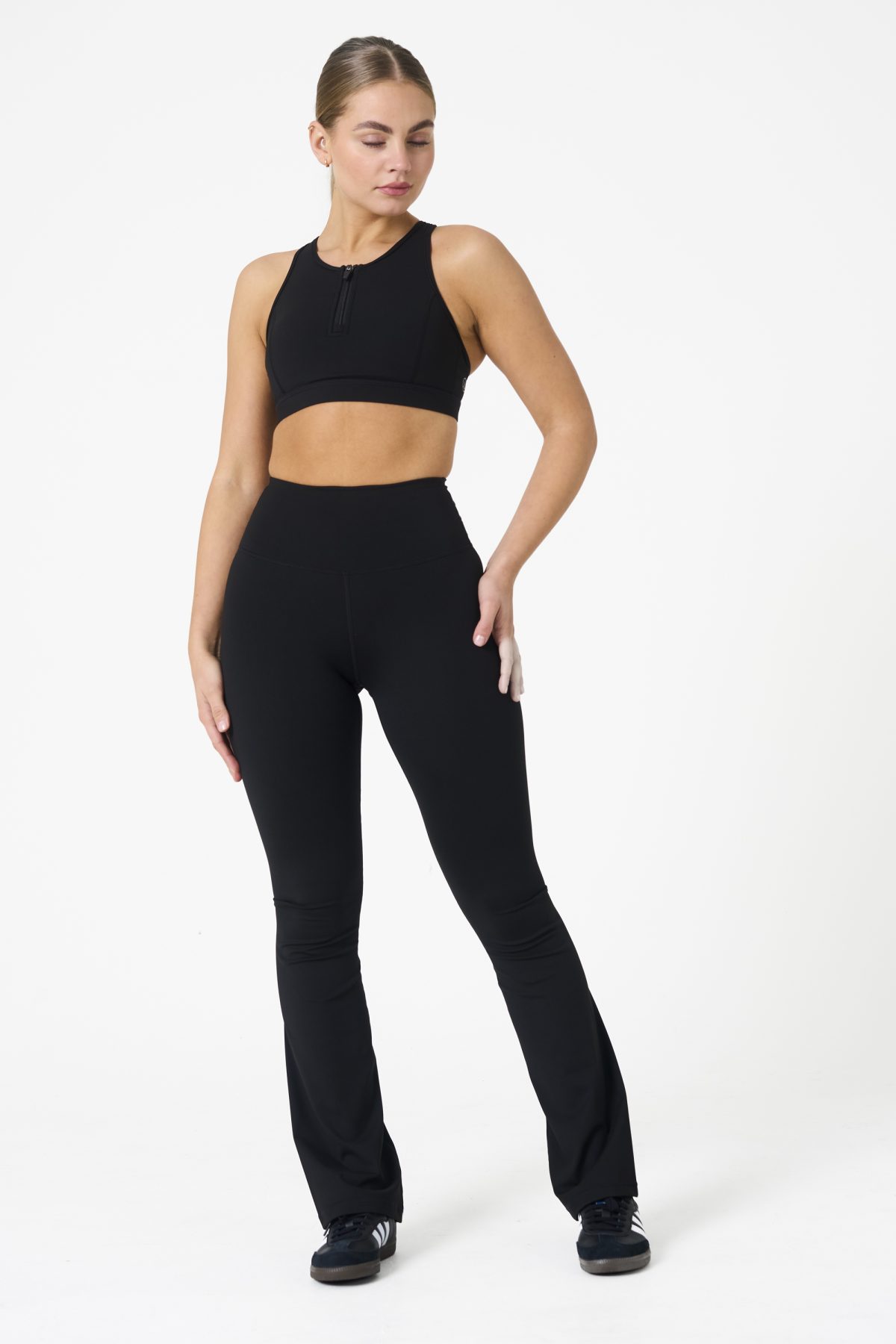 Move freely and confidently with the Legacy Flare Legging (Black), designed for comfort, support, and style. Part of our Legacy Activewear Collection, this legging combines innovative features with a modern flair to elevate your active wardrobe. The high-waisted design ensures a secure fit, while the flatline drawstring offers customizable support for every movement. The subtle back-enhanced detail adds a sculpted, flattering touch. The flare silhouette delivers a trendy yet functional look, giving you ease of movement whether you're in the gym or out and about.