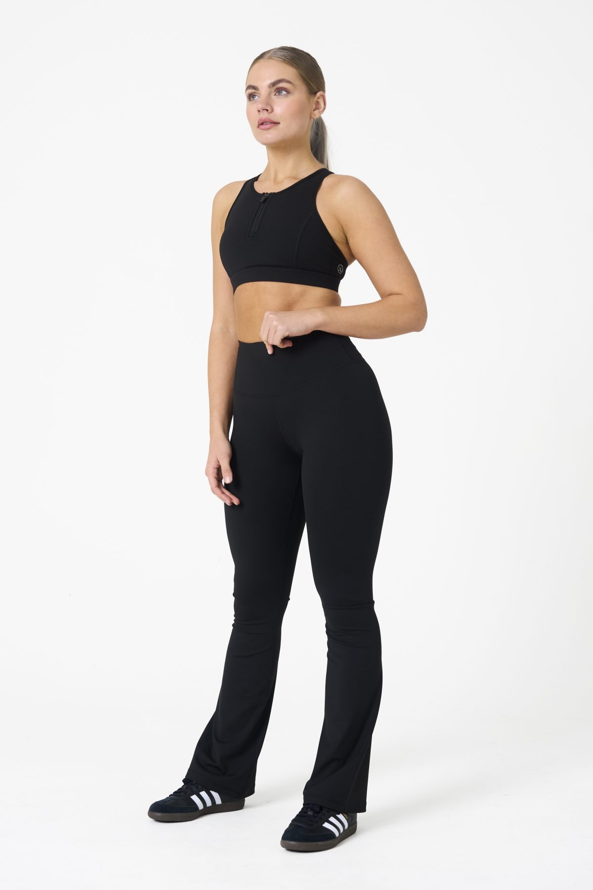 Move freely and confidently with the Legacy Flare Legging (Black), designed for comfort, support, and style. Part of our Legacy Activewear Collection, this legging combines innovative features with a modern flair to elevate your active wardrobe. The high-waisted design ensures a secure fit, while the flatline drawstring offers customizable support for every movement. The subtle back-enhanced detail adds a sculpted, flattering touch. The flare silhouette delivers a trendy yet functional look, giving you ease of movement whether you're in the gym or out and about.