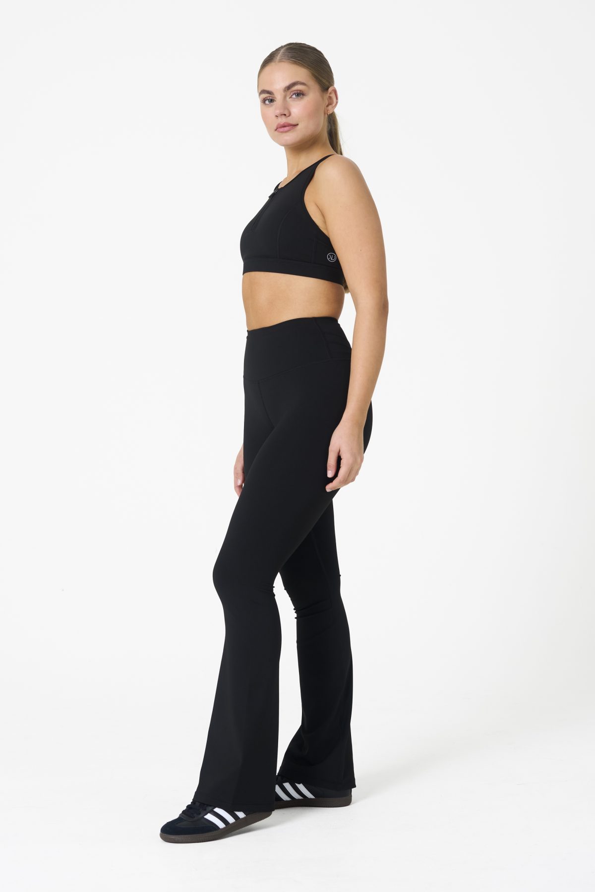 Move freely and confidently with the Legacy Flare Legging (Black), designed for comfort, support, and style. Part of our Legacy Activewear Collection, this legging combines innovative features with a modern flair to elevate your active wardrobe. The high-waisted design ensures a secure fit, while the flatline drawstring offers customizable support for every movement. The subtle back-enhanced detail adds a sculpted, flattering touch. The flare silhouette delivers a trendy yet functional look, giving you ease of movement whether you're in the gym or out and about.