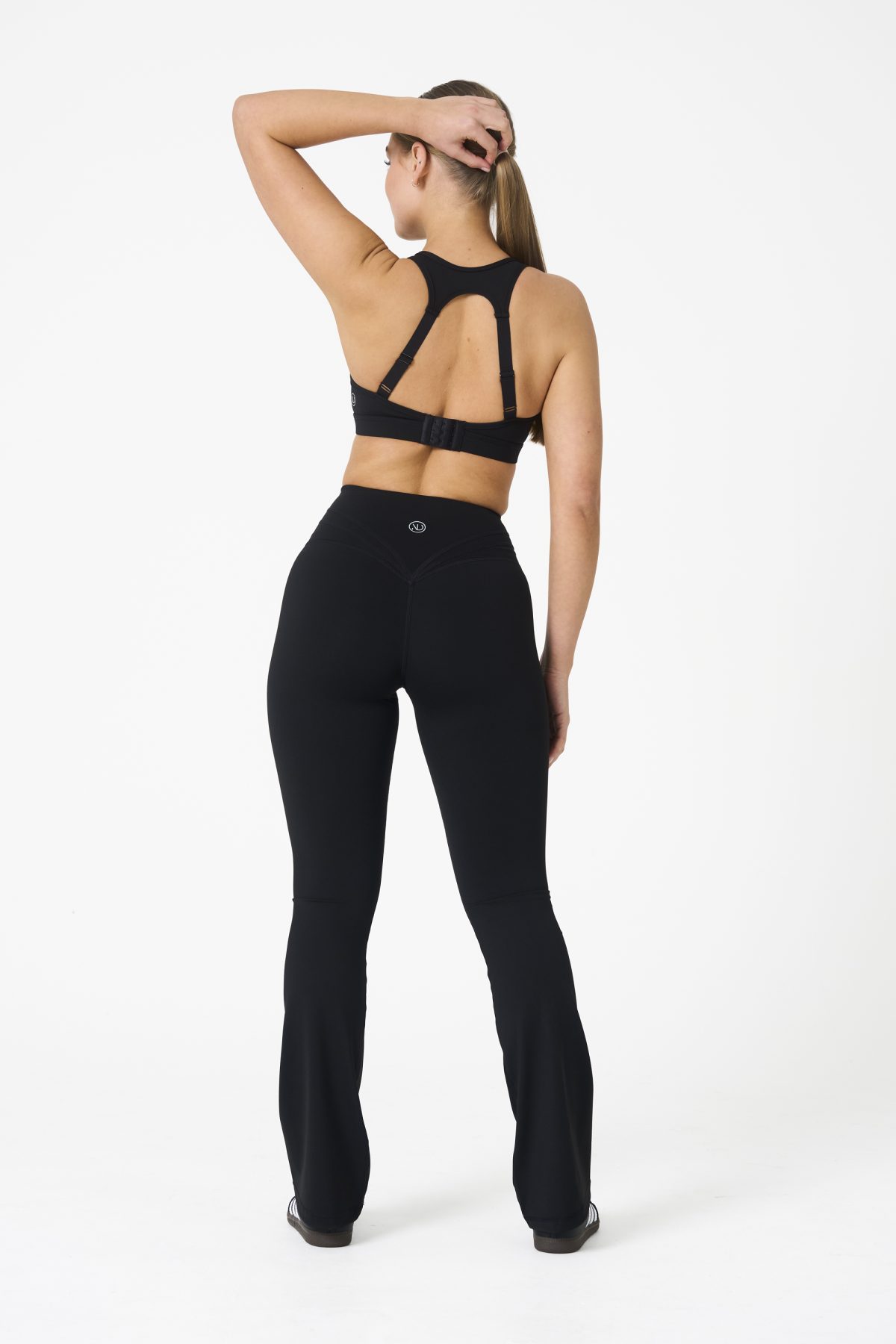 Move freely and confidently with the Legacy Flare Legging (Black), designed for comfort, support, and style. Part of our Legacy Activewear Collection, this legging combines innovative features with a modern flair to elevate your active wardrobe. The high-waisted design ensures a secure fit, while the flatline drawstring offers customizable support for every movement. The subtle back-enhanced detail adds a sculpted, flattering touch. The flare silhouette delivers a trendy yet functional look, giving you ease of movement whether you're in the gym or out and about.