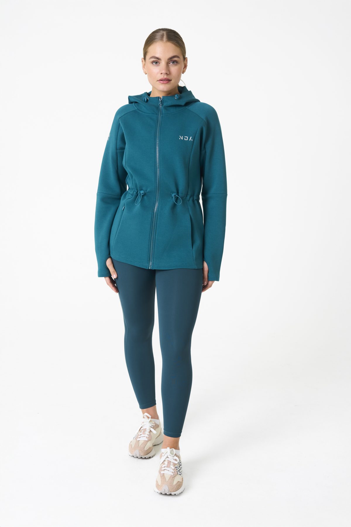 Elevate your activewear game with the Legacy Zip Hoodie (Dark Teal) from our Legacy Activewear Collection. Designed for ultimate movement, support, and comfort, this hoodie seamlessly blends practicality with style. The full-zip closure offers effortless wearability, while the adjustable hood and elasticated waist ensure a personalized fit. Perfect for your on-the-go lifestyle, it features two convenient pockets: a secure zipped pocket for essentials and a classic open pocket for quick access. The Legacy Zip Hoodie is your go-to for both functionality and trend-forward fashion.