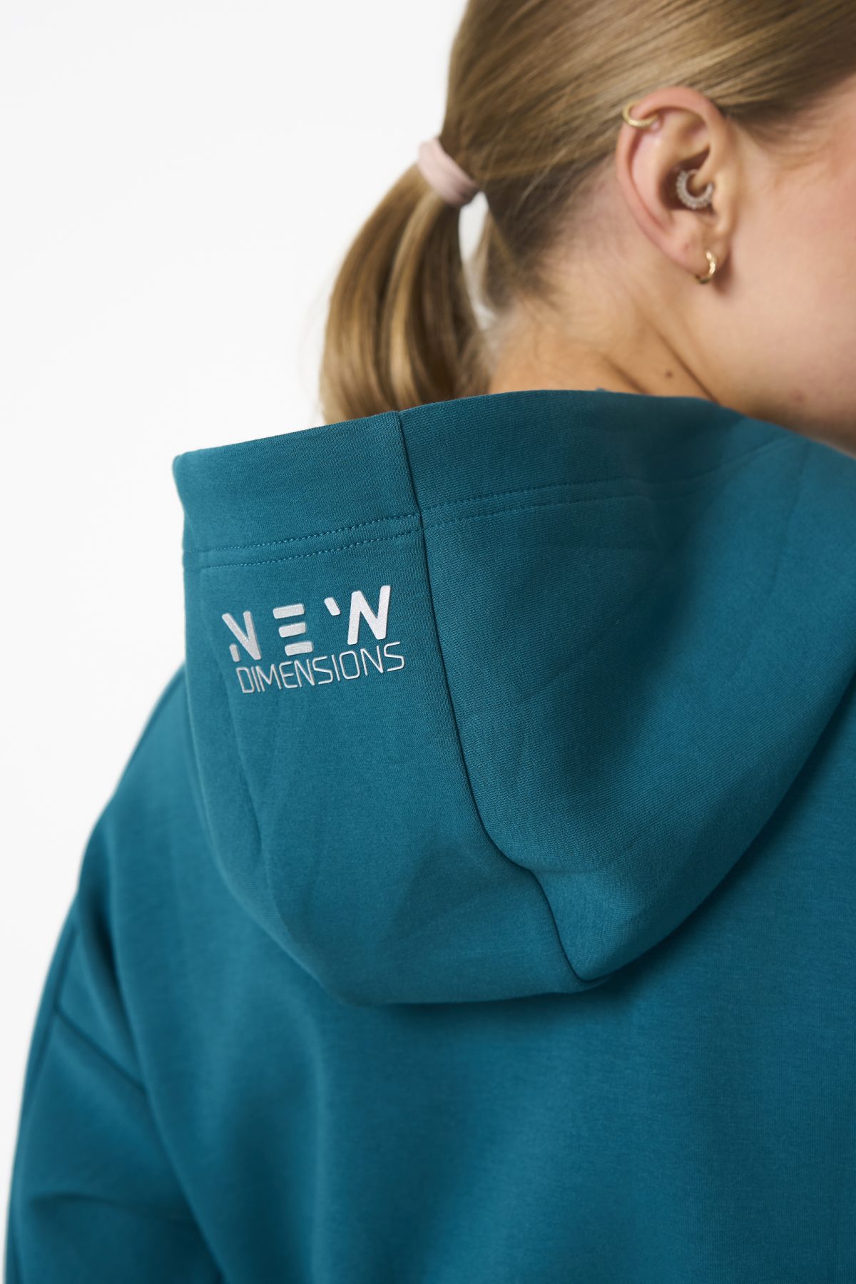 Elevate your activewear game with the Legacy Zip Hoodie (Dark Teal) from our Legacy Activewear Collection. Designed for ultimate movement, support, and comfort, this hoodie seamlessly blends practicality with style. The full-zip closure offers effortless wearability, while the adjustable hood and elasticated waist ensure a personalized fit. Perfect for your on-the-go lifestyle, it features two convenient pockets: a secure zipped pocket for essentials and a classic open pocket for quick access. The Legacy Zip Hoodie is your go-to for both functionality and trend-forward fashion.