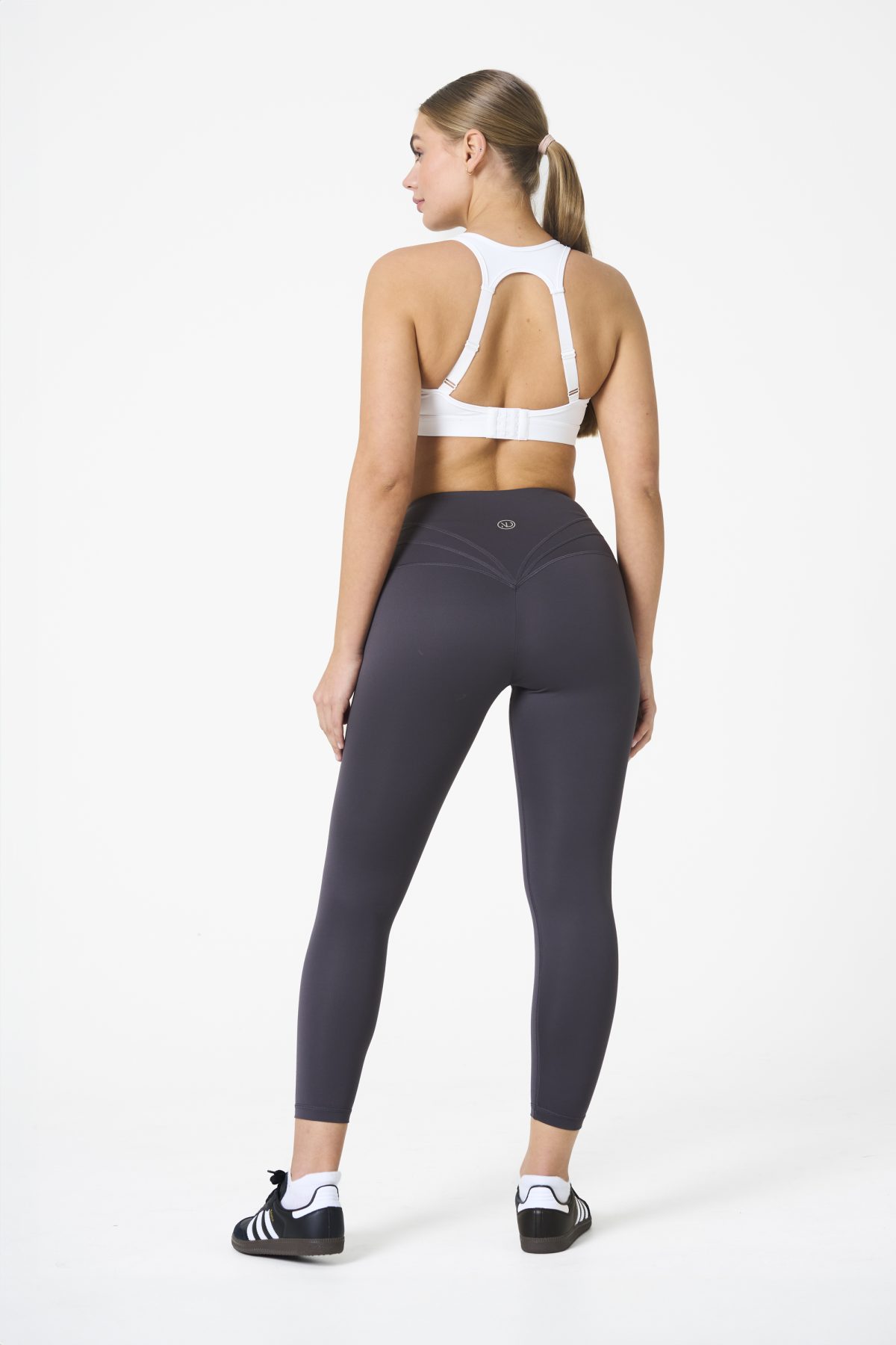 Elevate your workout wardrobe with the Legacy Legging (Dark Grey), designed to empower every movement. Part of our Legacy Activewear Collection, these leggings combine superior support, unmatched comfort, and timeless style. Featuring a high-waisted fit with a flat-line drawstring for adjustable comfort, these leggings are crafted to stay put through every squat, lunge, and stretch. The back-enhanced detail adds a flattering finish, making these leggings a staple for both gym sessions and casual wear.