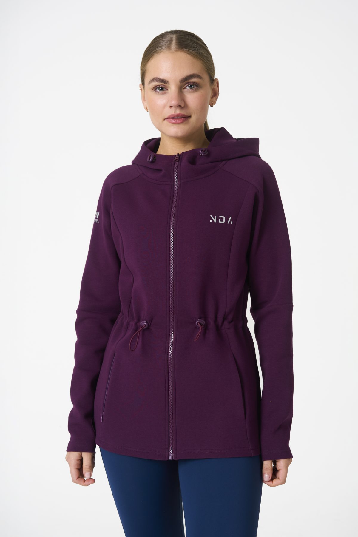 Elevate your activewear game with the Legacy Zip Hoodie (Mulberry) from our Legacy Activewear Collection. Designed for ultimate movement, support, and comfort, this hoodie seamlessly blends practicality with style. The full-zip closure offers effortless wearability, while the adjustable hood and elasticated waist ensure a personalized fit. Perfect for your on-the-go lifestyle, it features two convenient pockets: a secure zipped pocket for essentials and a classic open pocket for quick access. The Legacy Zip Hoodie is your go-to for both functionality and trend-forward fashion.