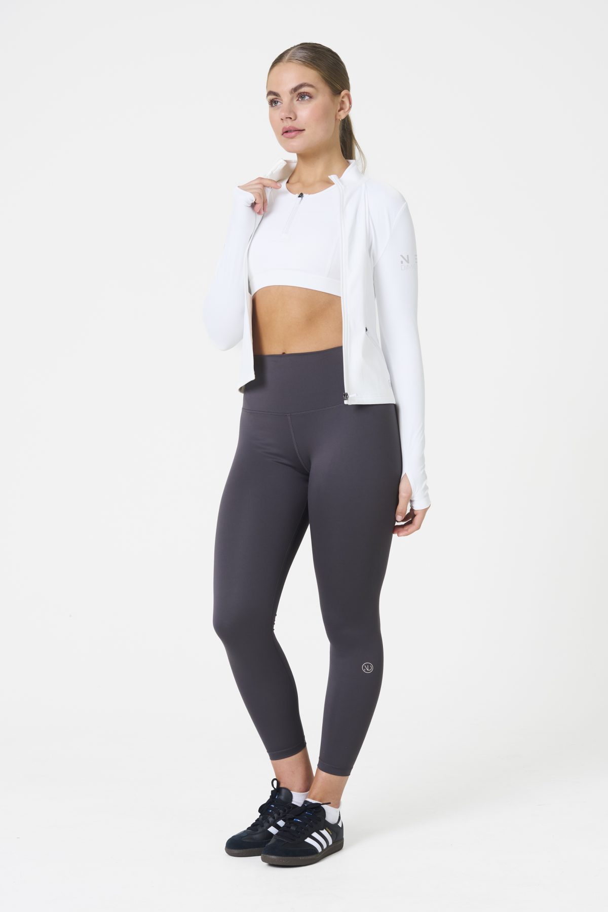 Elevate your activewear game with the Legacy Zip Jacket (White), designed for those who value movement, support, and unmatched comfort. Crafted from a premium blend of 75% Nylon and 25% Spandex, this jacket offers a lightweight yet durable feel that keeps you supported during any activity.