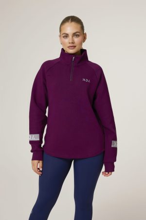 Premium & Practical - the Deluxe ¼ Zip (Mulberry). Made from our deluxe material, this 1/4 zip is designed to keep you warm and cosy during the colder months. The fabric is soft & heavy to the touch and provides ultimate comfort, making it a must-have for your wardrobe. Featuring a 1/4 zip and two pop up buttons on each side, this 1/4 zip not only offers functionality but also adds a touch of style to your look. The zipper allows for easy wear and the buttons add a unique element to the design.