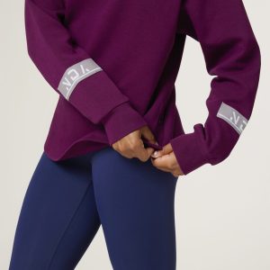Premium & Practical - the Deluxe ¼ Zip (Mulberry). Made from our deluxe material, this 1/4 zip is designed to keep you warm and cosy during the colder months. The fabric is soft & heavy to the touch and provides ultimate comfort, making it a must-have for your wardrobe. Featuring a 1/4 zip and two pop up buttons on each side, this 1/4 zip not only offers functionality but also adds a touch of style to your look. The zipper allows for easy wear and the buttons add a unique element to the design.