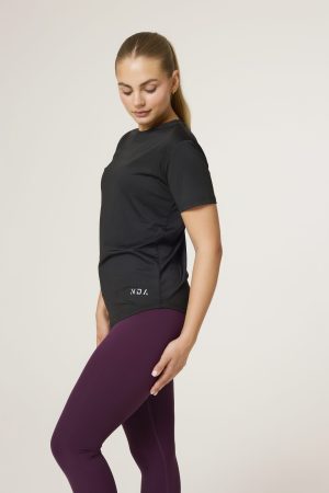 Introducing the Women's Training Tee (Black) - the ultimate workout companion for fitness enthusiasts! Made with a perfect blend of polyester and spandex, this tee offers maximum comfort and flexibility for all your training needs. This tee not only looks great but also allows for a full range of motion during your workouts. But what sets this training tee apart is its innovative heat gear technology. This technology is designed to quickly and efficiently pull sweat away from your skin, keeping you dry and comfortable even during the most intense training sessions.